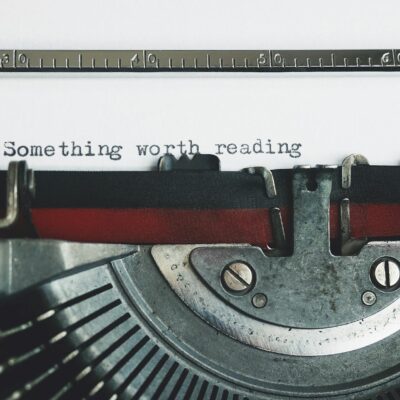 Black and Red Typewriter on White Table